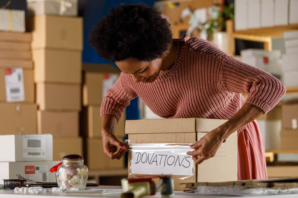 A woman preparing a donation box