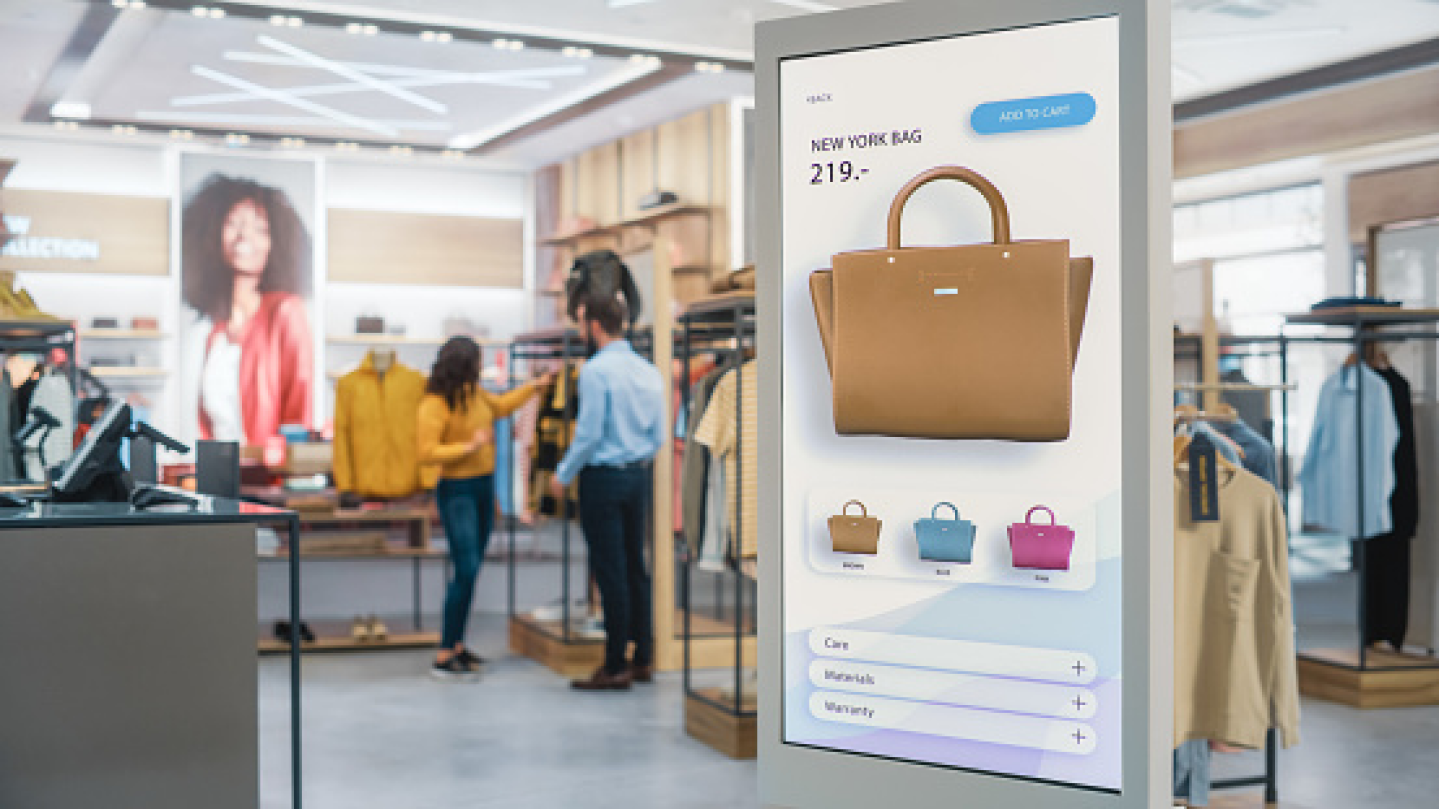 Image of an online shopping screen overlaid on a retail background