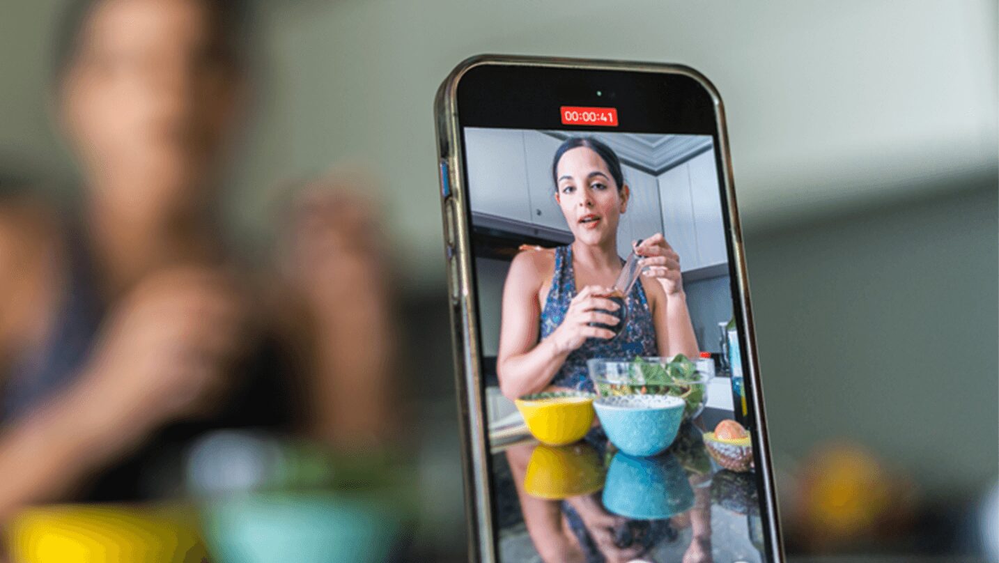 person recording themselves on their phone showing the shift in brand loyalty